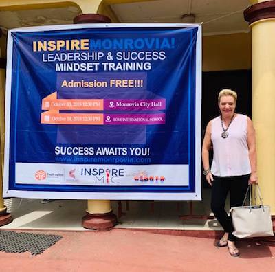 Natalie Ledwell with the Inspire Monrovia banner