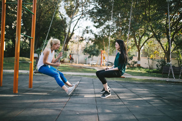 Women Chatting on Swings