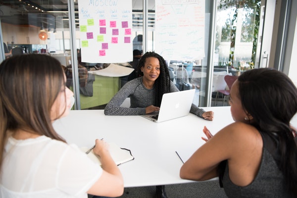 Woman Actively Listening to Colleagues