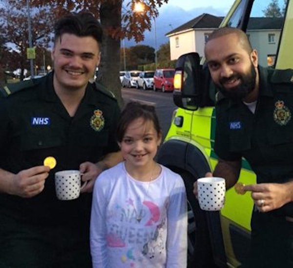 Little girl with two paramedics