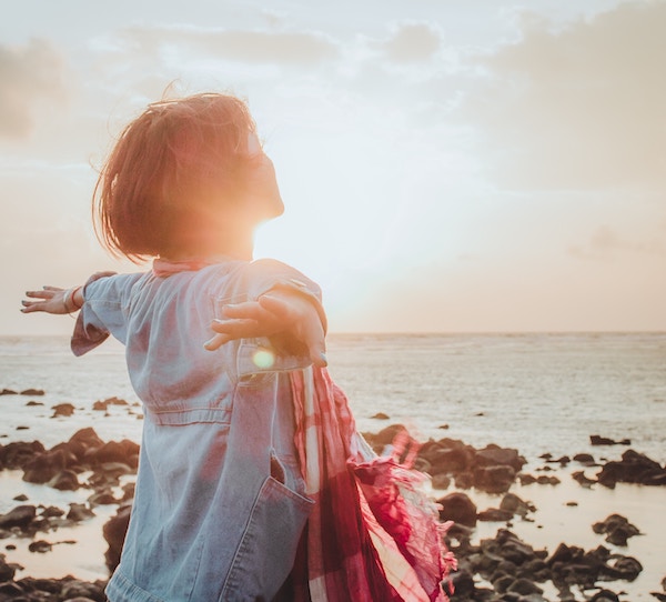 Woman Freely Looking Off into the Sunset