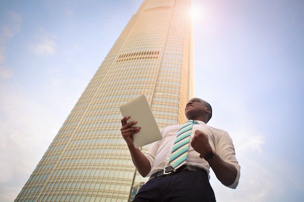 Excited Businessman in Front of Building