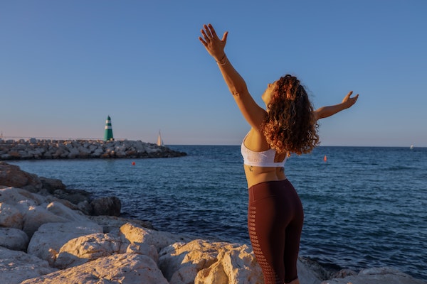 Woman Rejoicing as She Looks Towards the Ocean