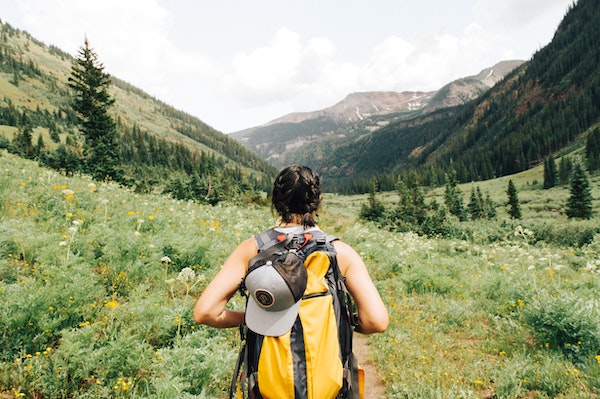 Woman Backpacking in Mountains