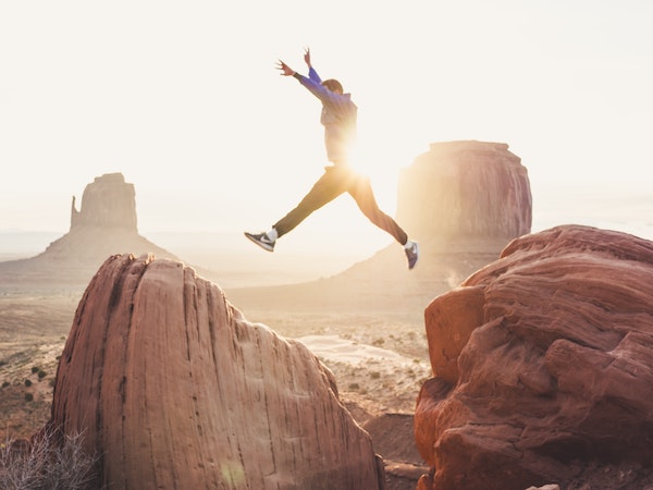 Man Leaping Between Rocks