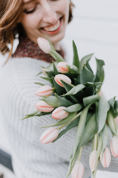 Woman Holding Bouquet of Flowers