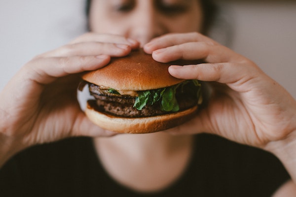 Person Holding a Hamburger