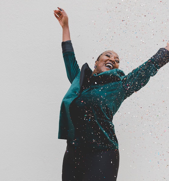 Happy Woman Jumping with Confetti