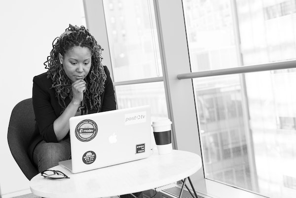 Woman Thinking While Looking at Her Computer