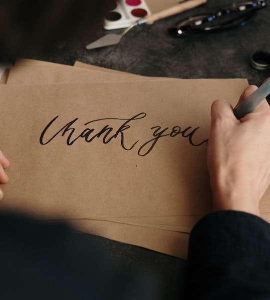 Person Writing a Thank You Note