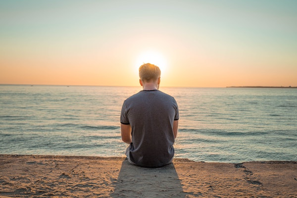 Man Overlooking Peaceful Ocean