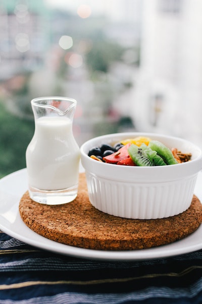 Bowl of Fruit and Cup of Milk