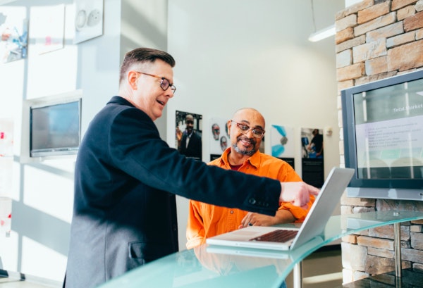 Two People Talking While Looking at Computer