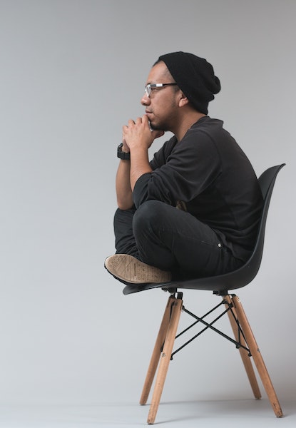 Man Thinking While Sitting in a Chair