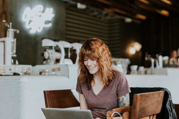 Happy Woman Looking at Computer