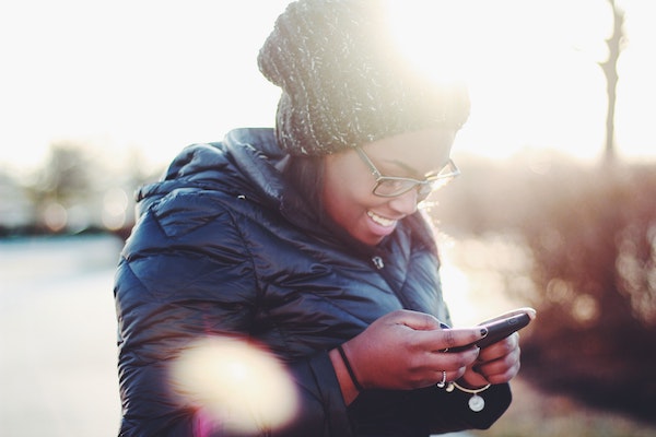 Happy Woman Looking at Phone