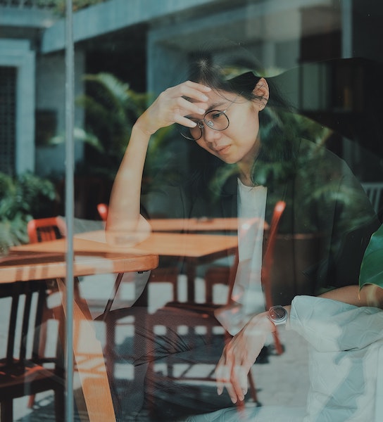 Woman Looking Out Window Feeling Sad