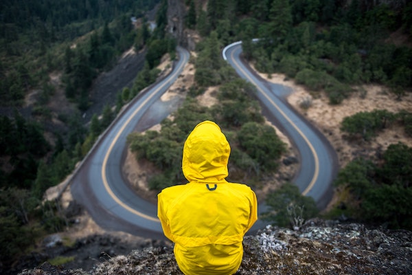 Person Overlooking Windy Road