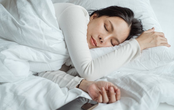 Woman Sleeping in a Bed