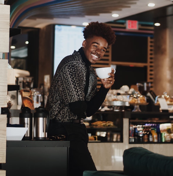 Man Smiling While Drinking Coffee