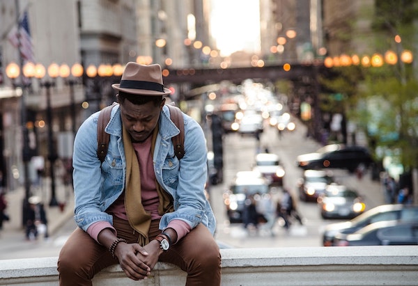 Sad Man Sitting on Bridge