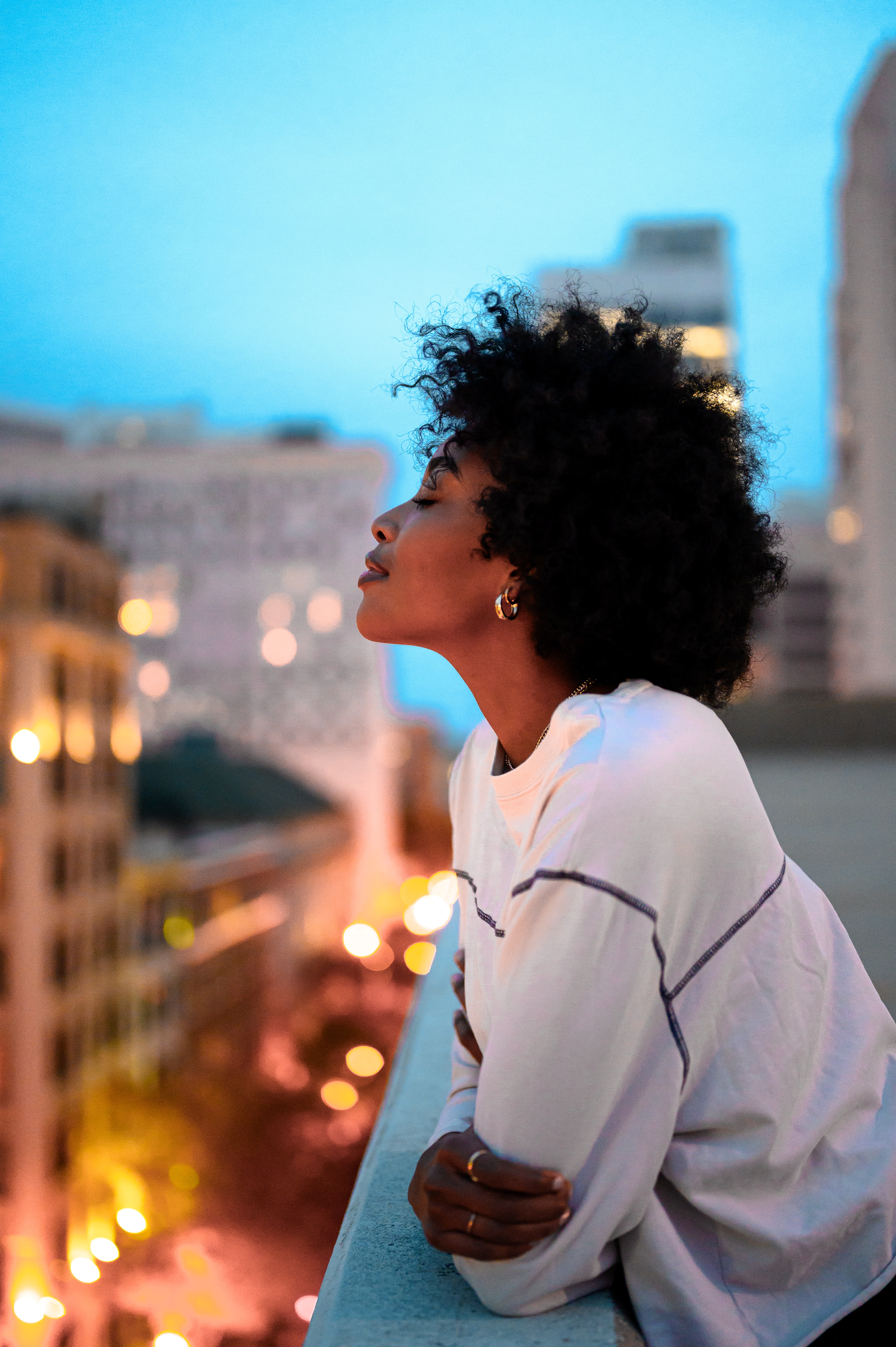 Woman Looking Out Over Balcony