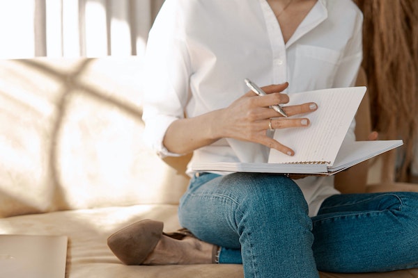 Woman Flipping Through Journal