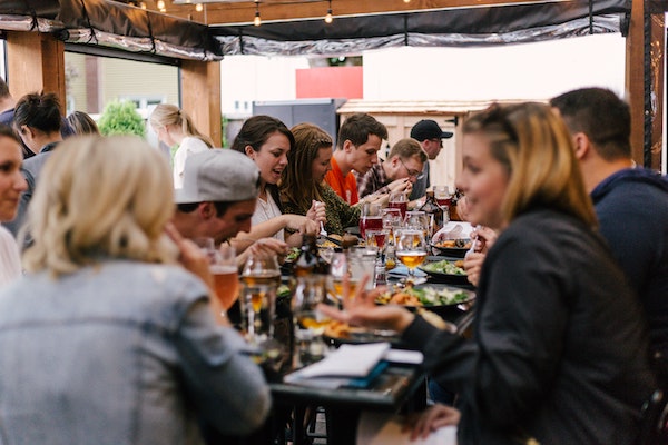 Large Group of People Eating Around a Table