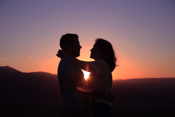 Couple Hugging With Sunset in The Background