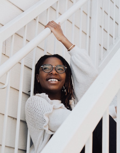 Happy Woman Sitting on Staircase