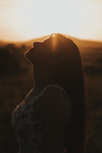 Women With Eyes Closed Basking In The Sun