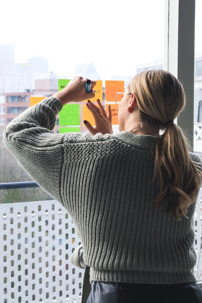 Woman Writing on Post-it Notes