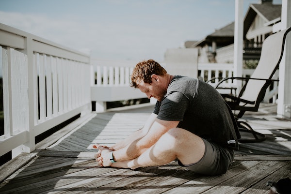 Man Stretching Outside At Home