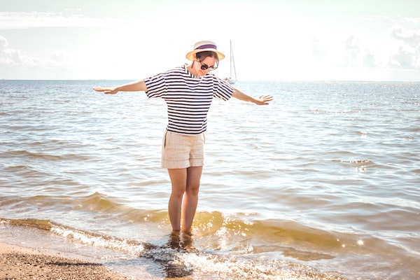 Woman at Beach With Feet in the Ocean