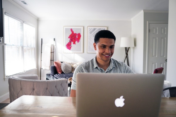 Smiling Man Sitting at Computer