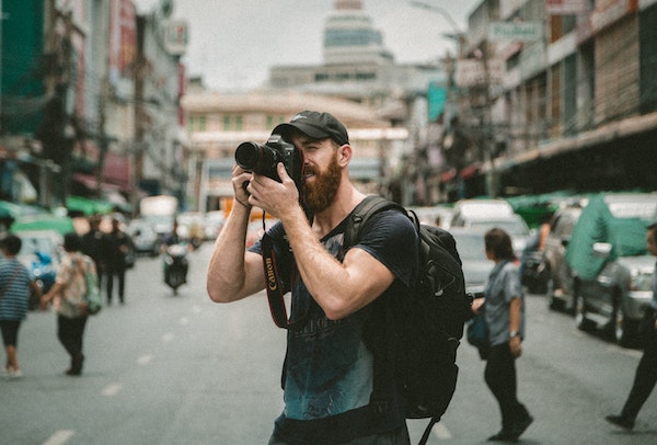 Photographer Taking Photos on Busy Street